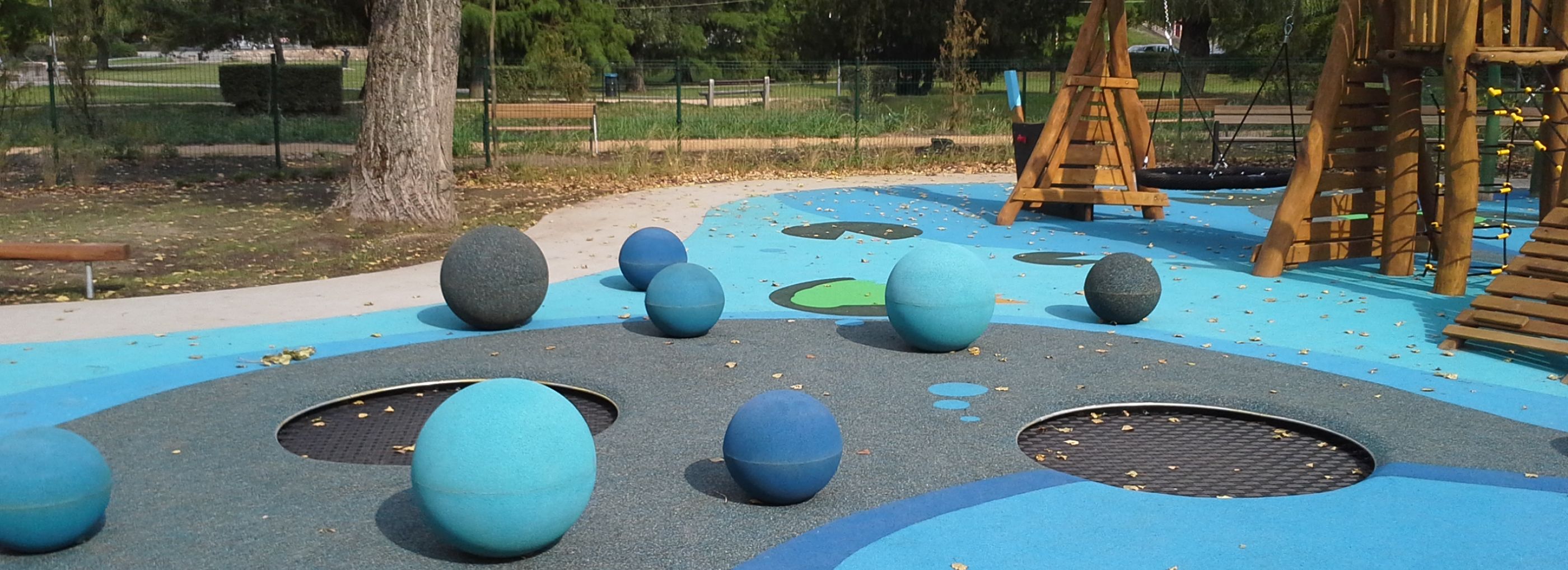 Blue coloured outdoor playground with plus spheres in different sizes and tones of blue.