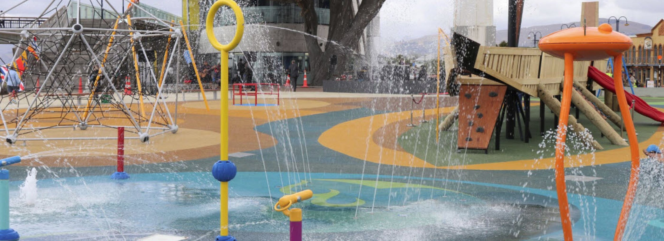Outdoor water park with colourful rubber flooring.